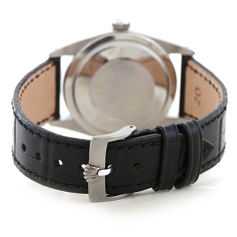 This image shows the back of a Vintage Collection Rolex watch, highlighting the watch back and black leather strap with a clasp.