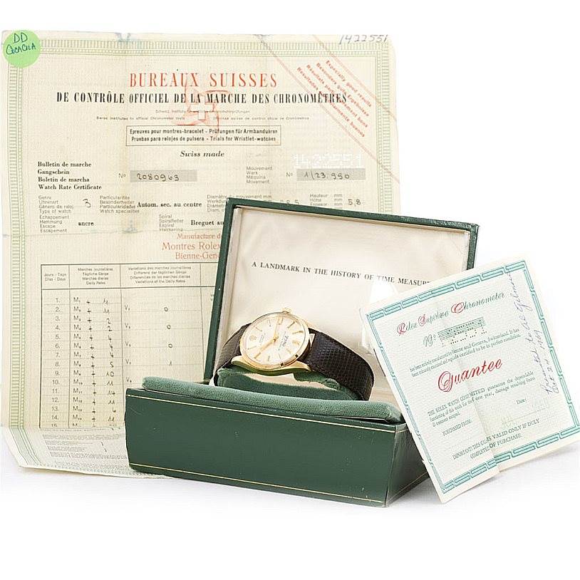 The image shows a Rolex Vintage Collection 1003 Yellow Gold Silver Dial 1003 Yellow Gold Silver Dial watch placed inside its green box along with official documentation and certificates.
