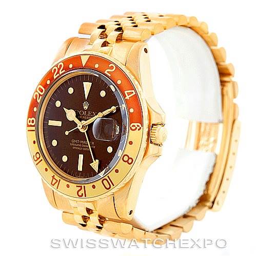 This image shows a Rolex Vintage Collection 1675 Men's Yellow Gold Brown Dial 1675 Men's Yellow Gold Brown Dial GMT-Master watch at an angled view, highlighting its dial, bezel, bracelet, and crown.