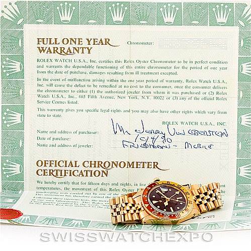 The image shows a Rolex Vintage Collection 1675 Men's Yellow Gold Brown Dial 1675 Men's Yellow Gold Brown Dial watch placed on its warranty and certification documents at an angle displaying the dial and bracelet.