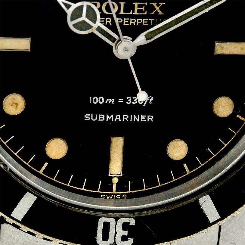 This close-up angle of the Rolex Vintage Collection 5508 Men's Stainless Steel Black Dial 5508 Men's Stainless Steel Black Dial Submariner watch highlights the dial, hands, depth rating, and a portion of the bezel.