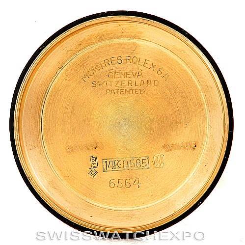 This image shows the inside of the back cover of a Rolex Vintage Collection 6564 Men's Yellow Gold Silver Dial 6564 Men's Yellow Gold Silver Dial watch, featuring model numbers and markings.