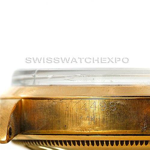 This image shows a close-up side view of the case and bezel of a Vintage Collection Rolex watch, highlighting the serial number and "14K" marking.