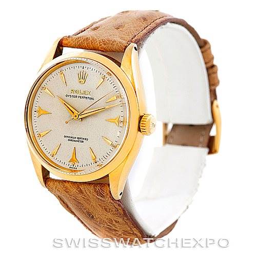 This image shows a side angle view of a Vintage Collection Rolex Oyster Perpetual watch with a brown leather strap.