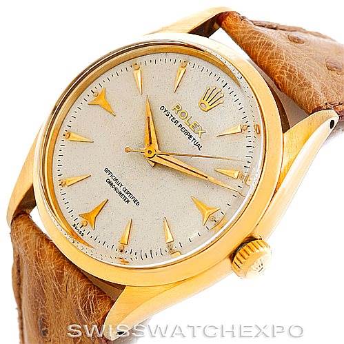 This Rolex Vintage Collection 6564 Men's Yellow Gold Silver Dial 6564 Men's Yellow Gold Silver Dial watch is shown from an angled top-side view, highlighting its dial, case, and leather strap.