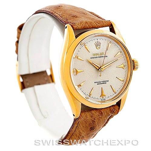 This Rolex Vintage Collection 6564 Men's Yellow Gold Silver Dial 6564 Men's Yellow Gold Silver Dial model watch is shown at a slight angled view, highlighting the face, bezel, and brown leather strap.