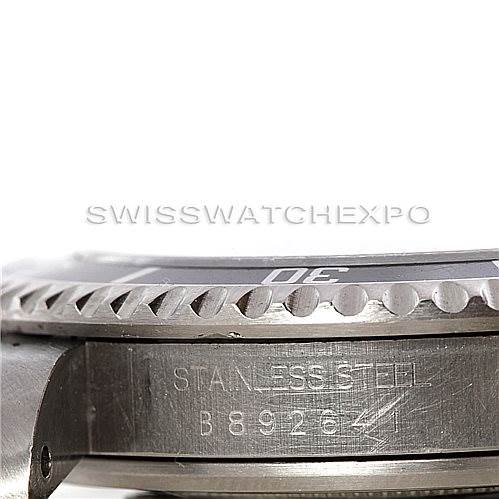 This image shows a close-up side angle of the Tudor Submariner 79190 Men's Stainless Steel Black Dial 79190 Men's Stainless Steel Black Dial watch, highlighting its stainless steel bezel and partial case with engravings.