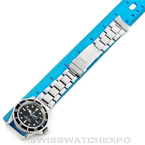 The image shows a top-down view of a Vintage Collection Rolex watch, including its face and stainless steel bracelet, next to a ruler for scale.