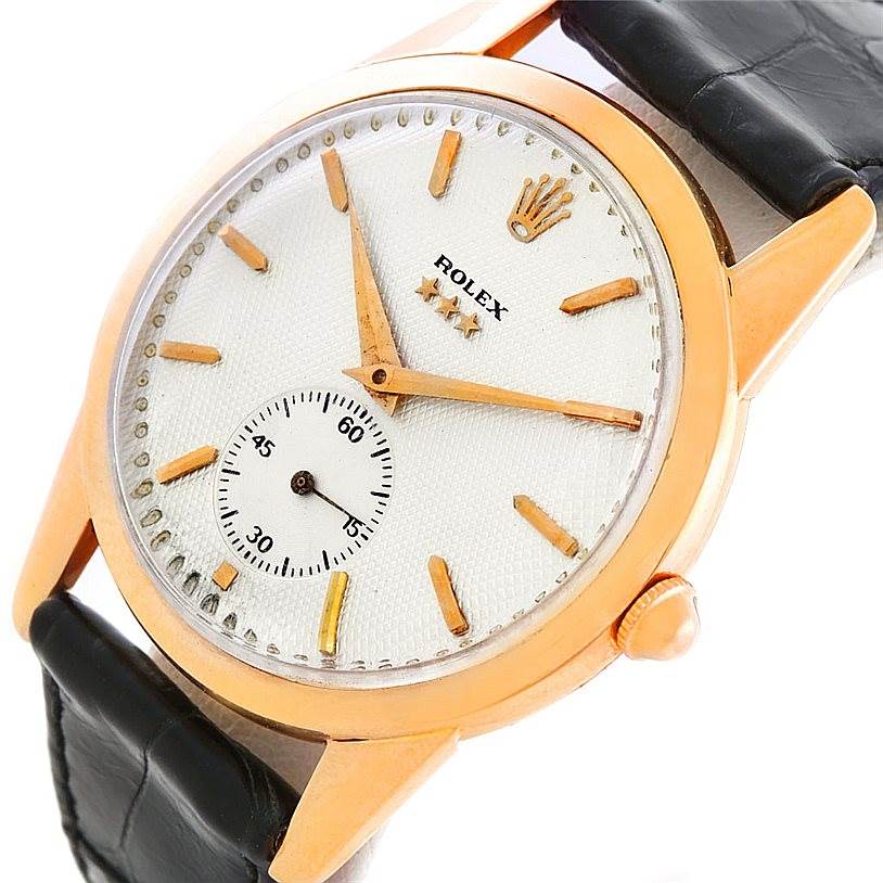 The image shows a close-up view of the face and black leather strap of a Vintage Collection Rolex watch.