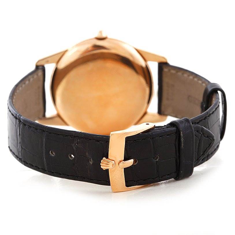 The image shows the back view of a Rolex Vintage Collection 8405 Men's Rose Gold Silver Dial 8405 Men's Rose Gold Silver Dial watch in gold with a black leather strap and gold buckle.