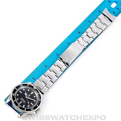 The image shows a Rolex Vintage Collection 5512 Men
s Stainless Steel  5512 Men
s Stainless Steel  watch, fully extended with a blue ruler placed alongside it for measurement.