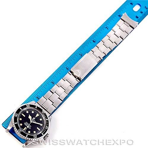 The image shows a Rolex Vintage Collection 5512 Men's Stainless Steel  5512 Men's Stainless Steel  watch laid flat next to a blue ruler for scale, displaying the watch face and metal bracelet.