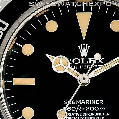Close-up is of a Rolex Vintage Collection 5512 Men's Stainless Steel  5512 Men's Stainless Steel  Submariner showing part of the dial, hour markers, hands, and part of the bezel.