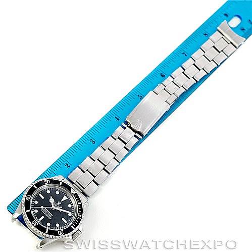 The image shows a top-down view of a Rolex Vintage Collection 5512 Men
s Stainless Steel  5512 Men
s Stainless Steel  watch beside a blue ruler, displaying the watch face, bracelet, and clasp.