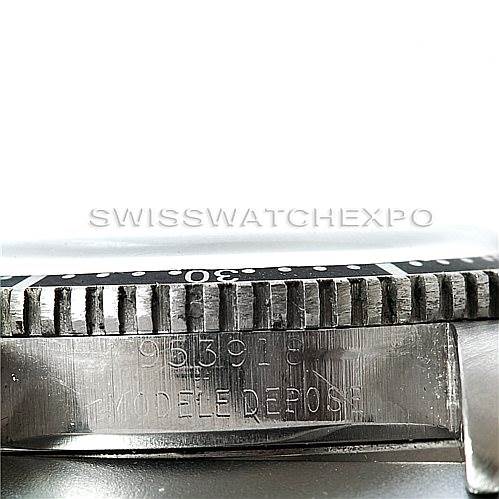 This close-up image of a Rolex Vintage Collection 6202 Men's Stainless Steel Black Dial 6202 Men's Stainless Steel Black Dial watch shows the serial number and the edge of the bezel.