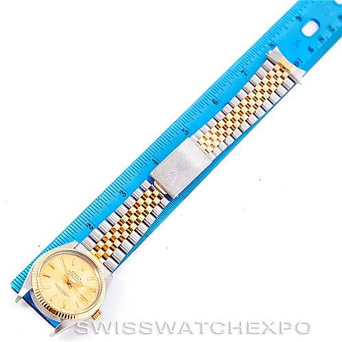 The Rolex Vintage Collection 16013 Men's Stainless Steel Champagne Dial 16013 Men's Stainless Steel Champagne Dial watch is shown from a top-down angle alongside a blue ruler for size reference.