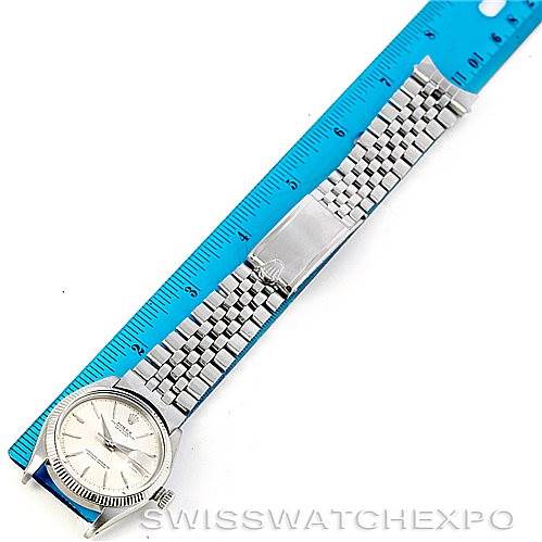 The watch, a Rolex Vintage Collection 1603 Men's Stainless Steel Silver Dial 1603 Men's Stainless Steel Silver Dial model, is shown from above, displaying its dial, bracelet, and clasp, with a ruler beside it.