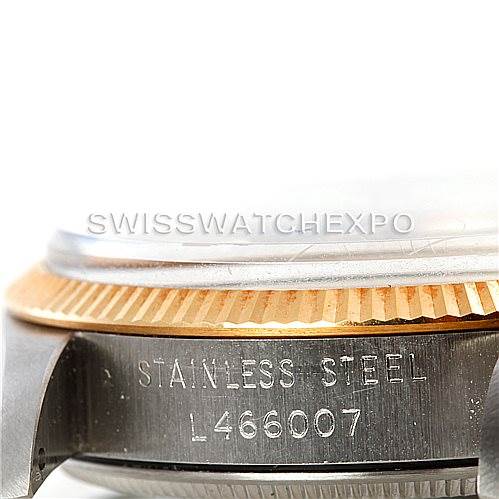 This image shows a close-up of the side of a Vintage Collection Rolex watch, focusing on the stainless steel case and part of the bezel.