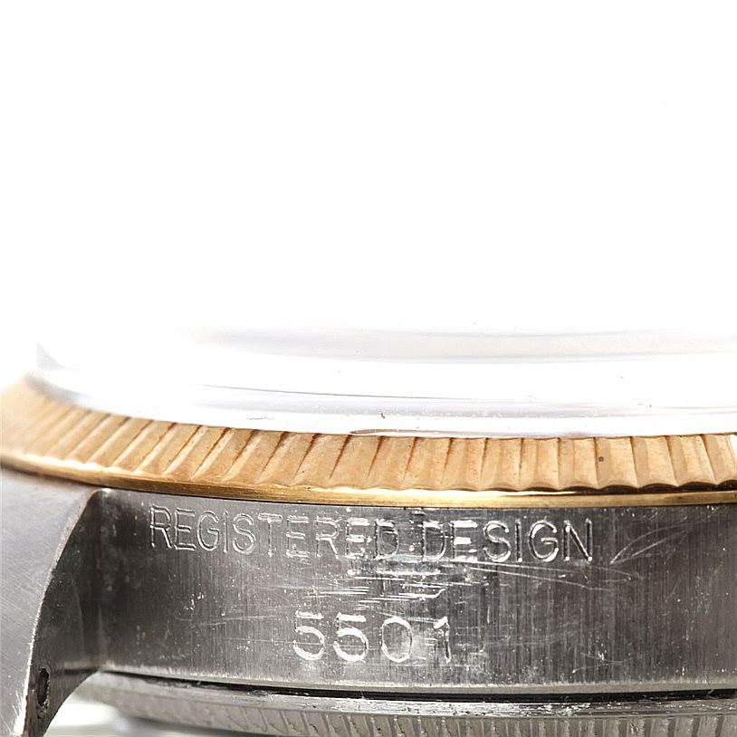 This close-up shows the side of the Rolex Vintage Collection 5501 Men's Steel and Gold (two tone) Silver Dial 5501 Men's Steel and Gold (two tone) Silver Dial model, highlighting the case edge with its "REGISTERED DESIGN 5501" engraving.