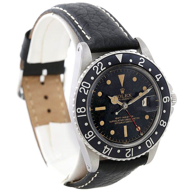 This image shows a side angle of a Rolex GMT-Master Vintage Collection watch, highlighting the face, bezel, and leather strap.