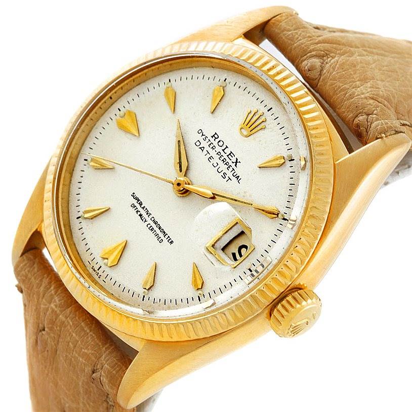 The image shows a close-up of the Rolex Vintage Collection 6605 Men's Yellow Gold Silver Dial 6605 Men's Yellow Gold Silver Dial Datejust watch, displaying the dial, crown, and part of the leather strap.