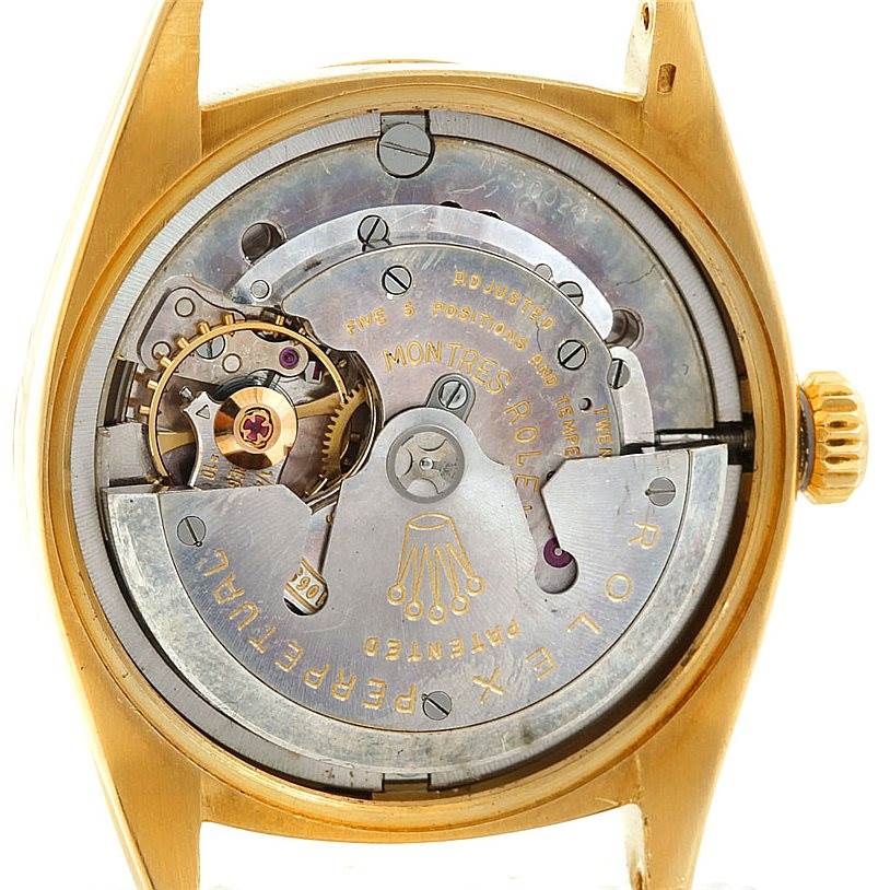 This image shows the internal mechanism of a Vintage Collection Rolex watch from a straight-on angle, displaying its intricate components.