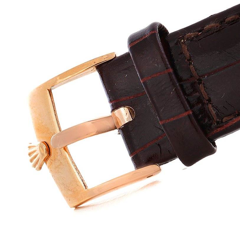 This image shows a close-up of the gold-tone buckle and brown strap of a Rolex Vintage Collection 4273 Men's Rose Gold Pink Dial 4273 Men's Rose Gold Pink Dial watch.