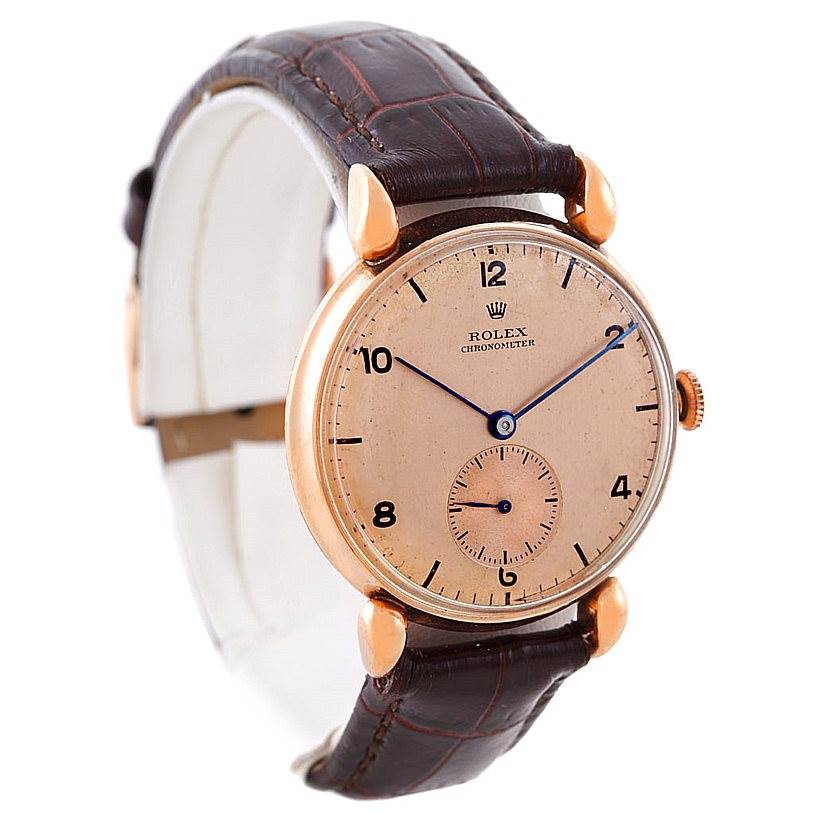 The image shows a side angle of a Rolex Vintage Collection 4273 Men's Rose Gold Pink Dial 4273 Men's Rose Gold Pink Dial watch, highlighting its face, leather strap, and case.