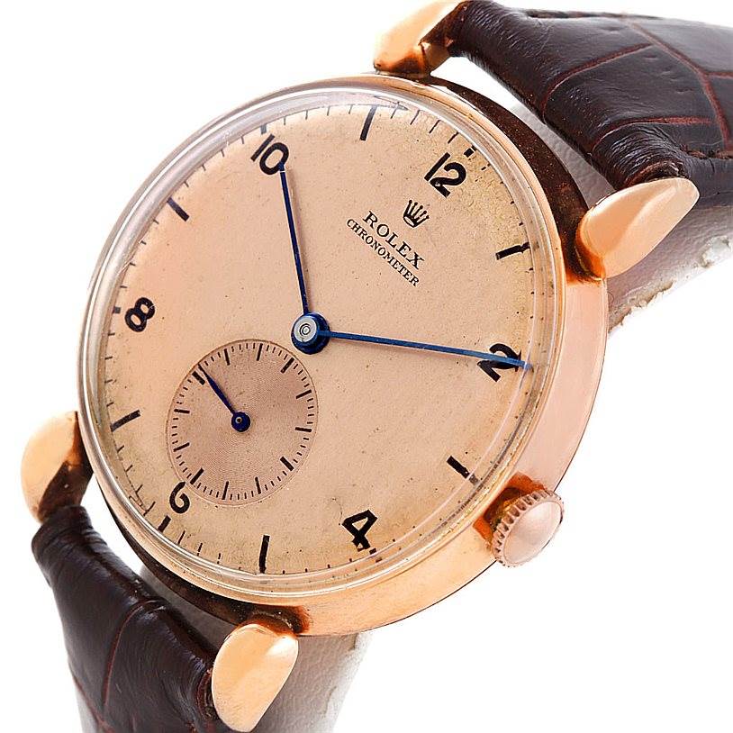 The image shows a close-up angle of the Rolex Vintage Collection 4273 Men's Rose Gold Pink Dial 4273 Men's Rose Gold Pink Dial watch face and part of its leather strap.