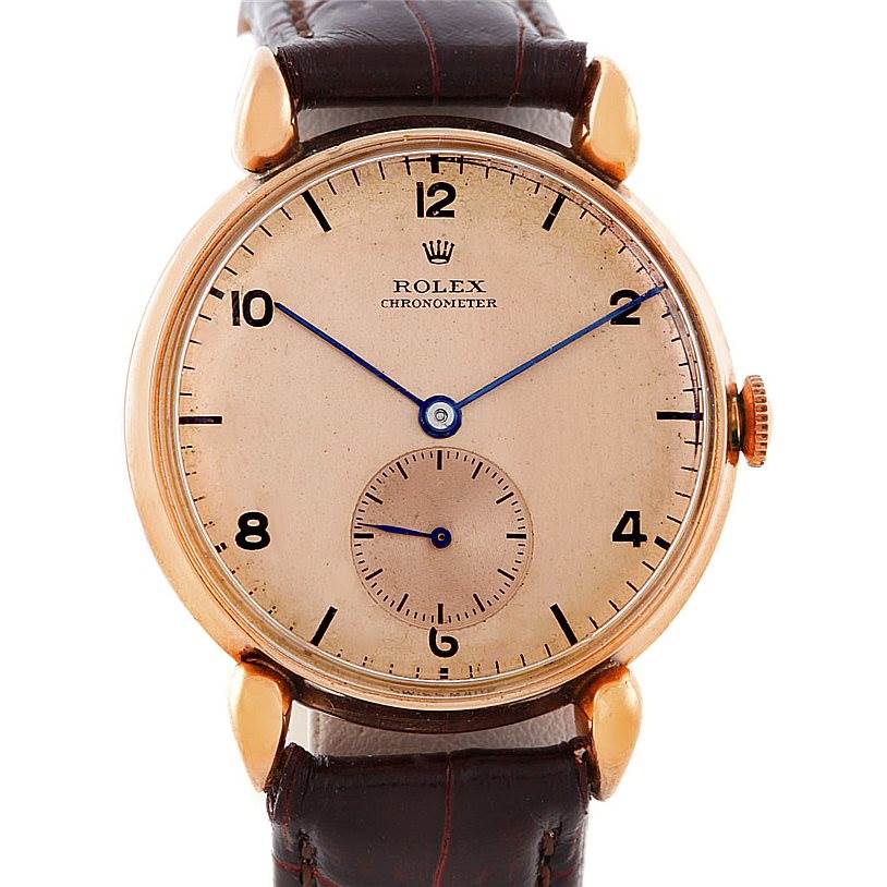 The image shows a frontal view of the Rolex Vintage Collection 4273 Men's Rose Gold Pink Dial 4273 Men's Rose Gold Pink Dial Chronometer, featuring its dial, crown, and leather strap.