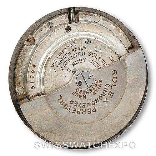 This image shows a close-up view of the movement mechanism of a Rolex Vintage Collection 6085 Men's Stainless Steel Silver Dial 6085 Men's Stainless Steel Silver Dial watch, highlighting its internal components and engravings.