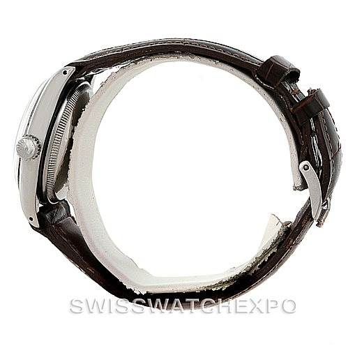 This image shows a side view of the Rolex Vintage Collection 6085 Men's Stainless Steel Silver Dial 6085 Men's Stainless Steel Silver Dial watch, highlighting the crown, case, and brown leather strap.