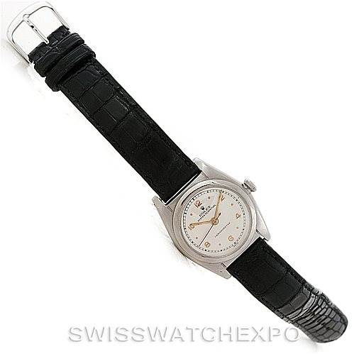 This image shows a Vintage Collection Rolex watch featuring a silver dial and a black leather strap, viewed from an angled top-down perspective.