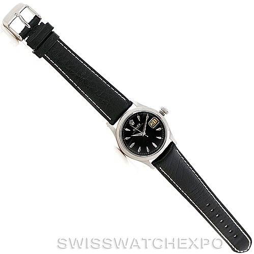 This image shows a top-down view of a Vintage Collection Rolex watch with a black leather strap and a silver buckle.