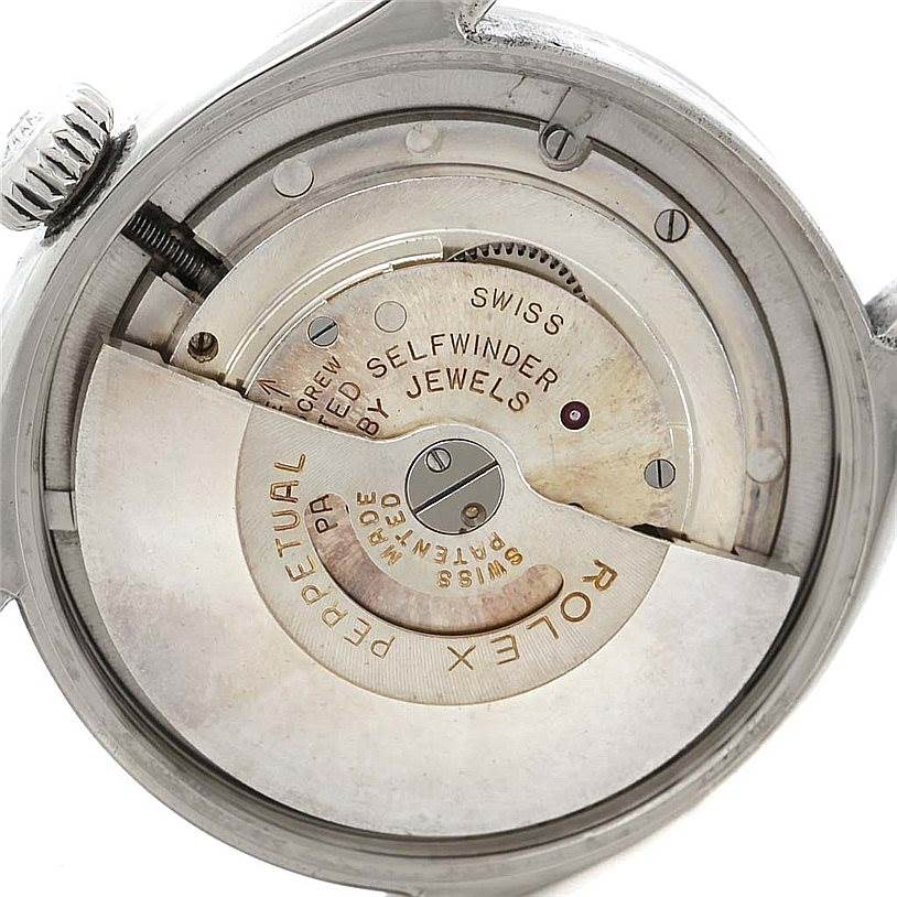 The image shows the internal mechanism of the Rolex Vintage Collection 6285 Men's Stainless Steel Silver Dial 6285 Men's Stainless Steel Silver Dial watch, highlighting the self-winding rotor and intricate parts.