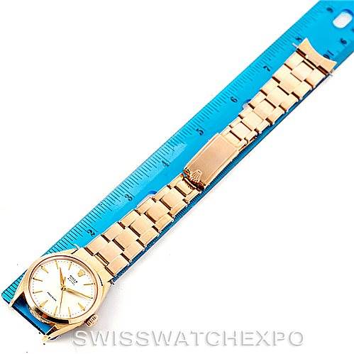 The Rolex Vintage Collection 6426 Men's Silver Dial 6426 Men's Silver Dial watch is shown flat with its gold bracelet and face parallel to a blue ruler.
