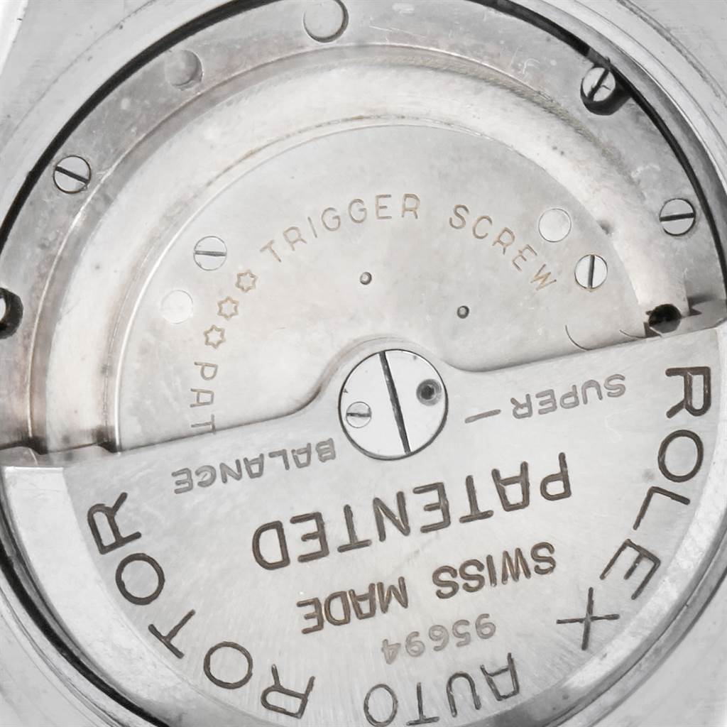 This image shows a close-up of the movement mechanism inside a Rolex Vintage Collection 3065 Men's Steel and Gold (two tone) Champagne Dial 3065 Men's Steel and Gold (two tone) Champagne Dial model watch, highlighting parts such as the rotor and engraving.