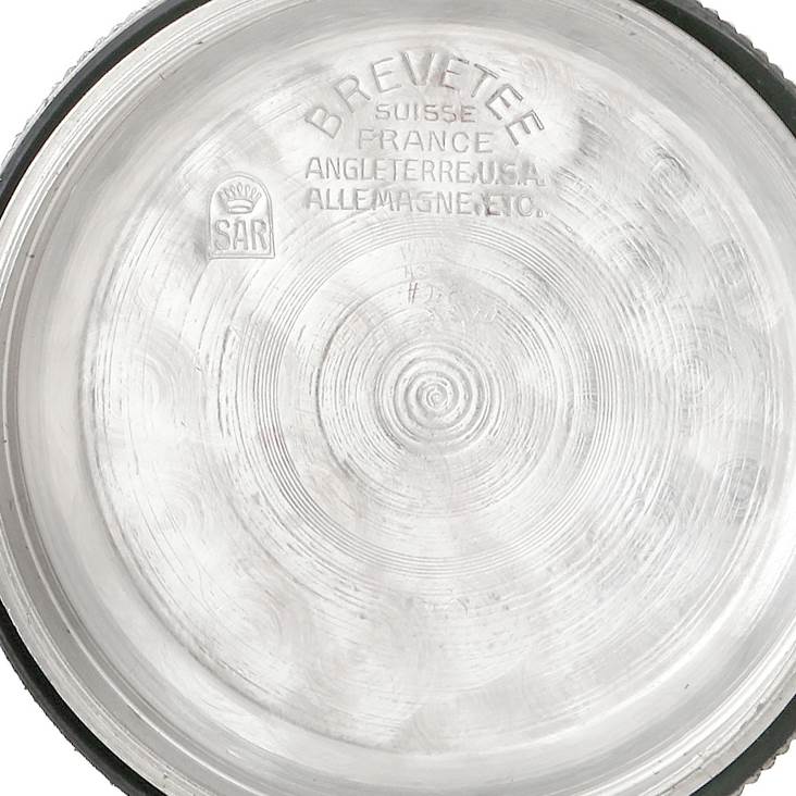 The image shows the inside of the case back of a Vintage Collection Rolex watch, displaying markings and engravings.