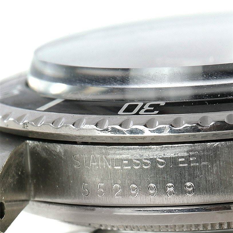 This close-up image shows the stainless steel case profile and bezel of a Vintage Collection Rolex watch.