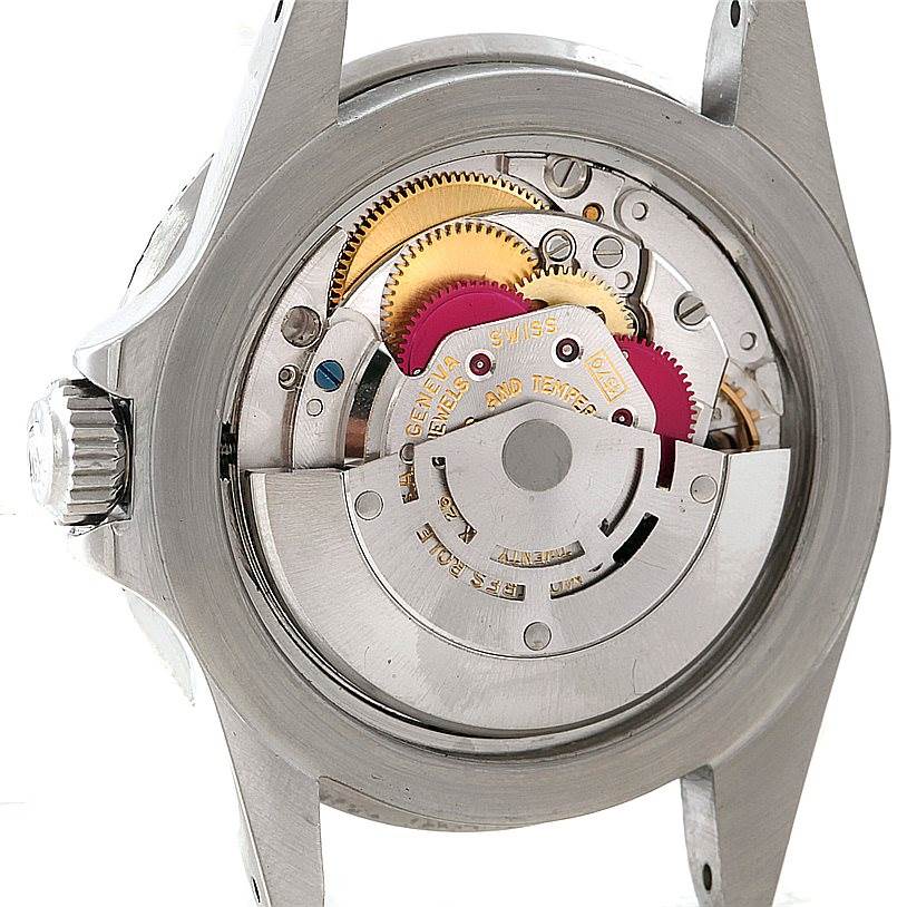 The image shows the inner mechanism and gears of a Vintage Collection Rolex watch from a rear angle with the case back removed.