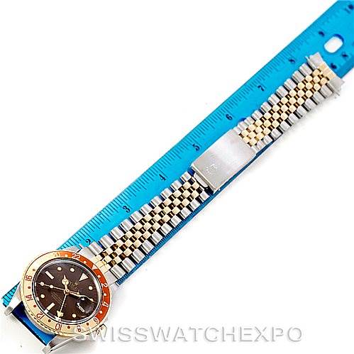 This image shows a Rolex Vintage Collection 16753 Men's Stainless Steel Brown Dial 16753 Men's Stainless Steel Brown Dial watch laid flat next to a blue ruler, displaying its face and two-tone metal bracelet.