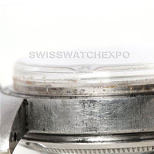 This image shows a close-up side view of the bezel and case of a Rolex Vintage Collection 6556 Men's Stainless Steel Silver Dial 6556 Men's Stainless Steel Silver Dial watch, showcasing its engraved details.