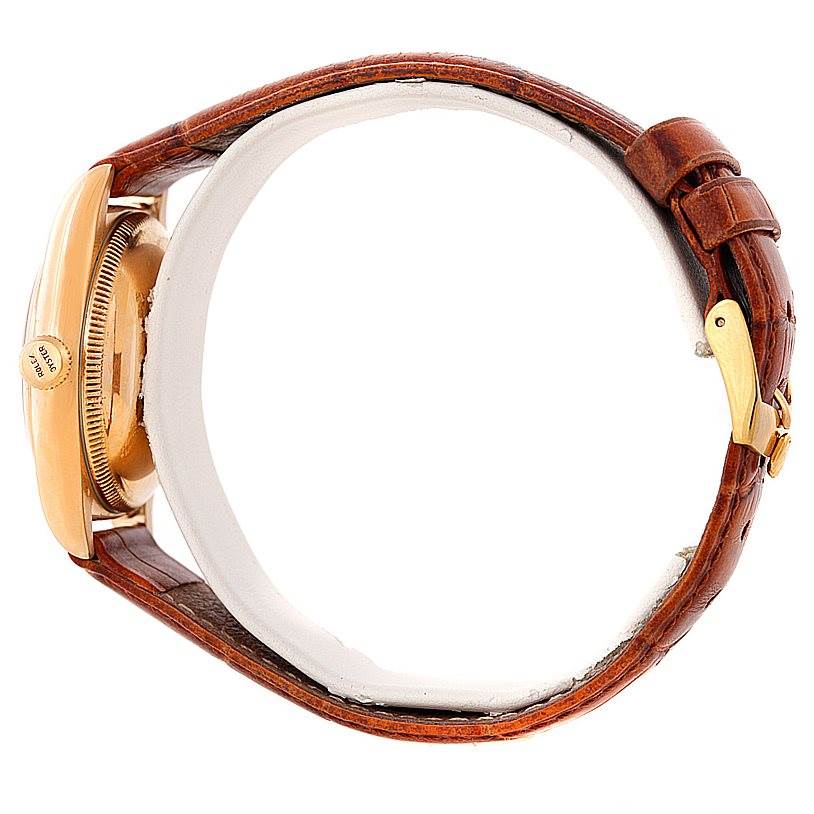 The image shows a side view of a Rolex Vintage Collection 3131 Men's Yellow Gold Silver Dial 3131 Men's Yellow Gold Silver Dial watch, highlighting its bezel, crown, and brown leather strap.