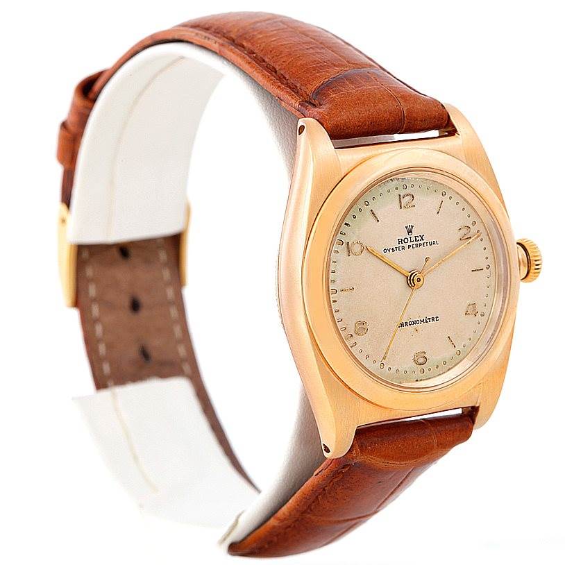 This is a side angle view of the Rolex Vintage Collection 3131 Men's Yellow Gold Silver Dial 3131 Men's Yellow Gold Silver Dial model watch, showing the face, crown, case, and brown leather strap.