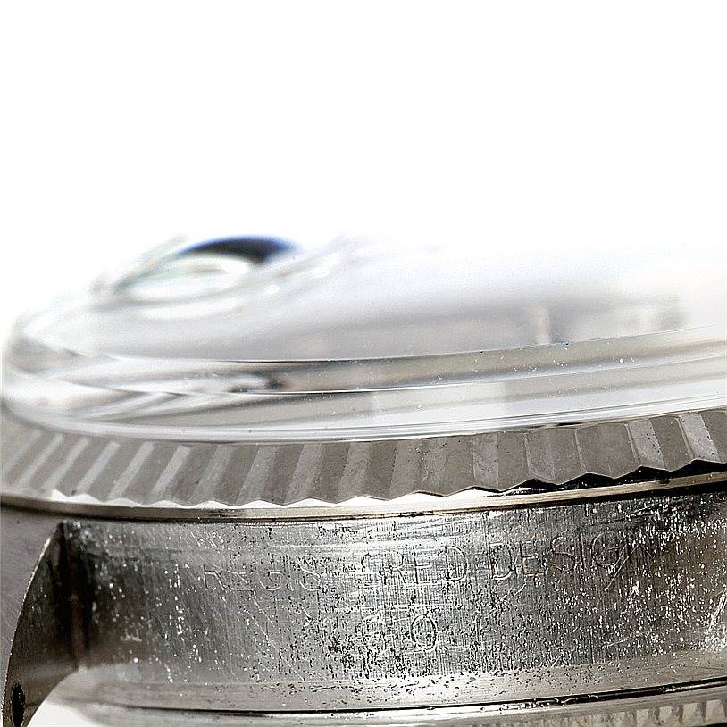 This close-up image of the Rolex Vintage Collection 1601 Men's Stainless Steel Silver Dial 1601 Men's Stainless Steel Silver Dial watch shows the side bezel and crystal dome.