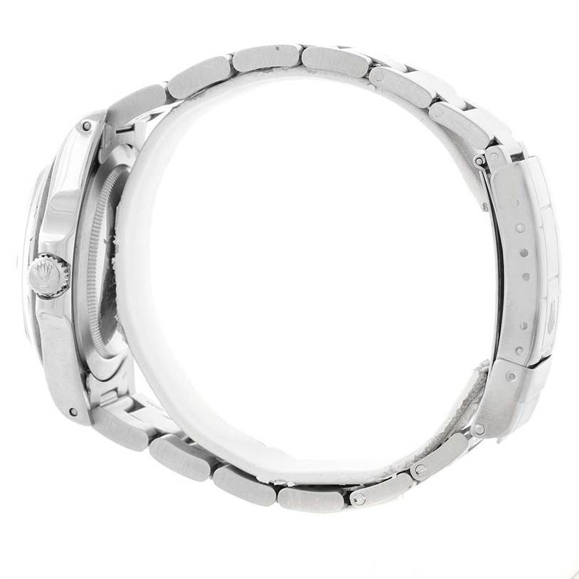 This side view of the Rolex Vintage Collection 1655 Men's Stainless Steel Black Dial 1655 Men's Stainless Steel Black Dial watch shows the crown, case, and metal bracelet.