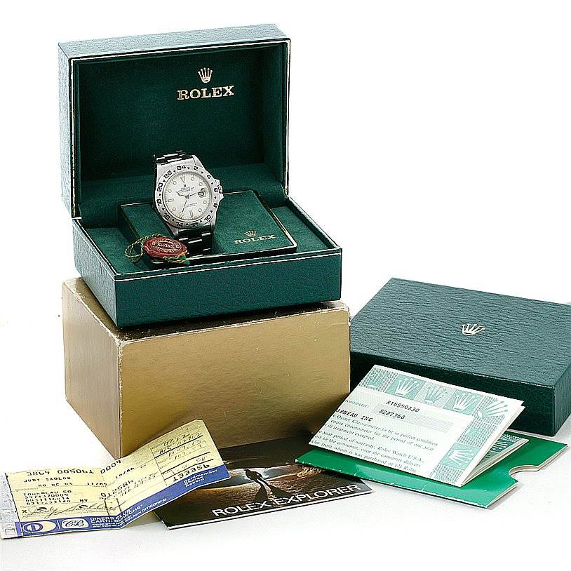 The Vintage Collection Rolex watch is displayed at a front angle, inside its box, with accompanying documents and tags.