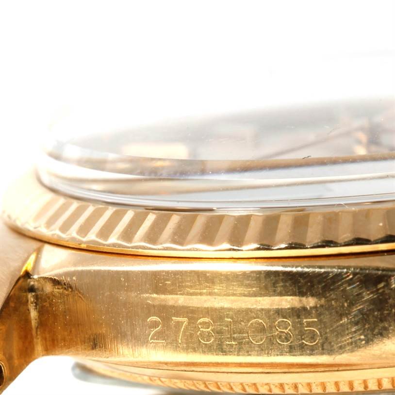 This close-up image shows the side view of a Rolex Vintage Collection 1601 Men's Yellow Gold Silver Dial 1601 Men's Yellow Gold Silver Dial watch's case, bezel, and crystal, with part of its serial number visible.