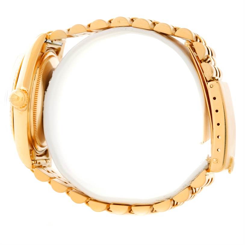 The image shows a side angle view of the Rolex Vintage Collection 1601 Men's Yellow Gold Silver Dial 1601 Men's Yellow Gold Silver Dial watch, highlighting the crown, bezel, and bracelet.