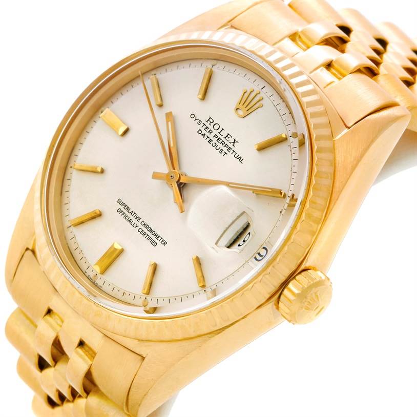 The image shows a close-up angle of the Rolex Vintage Collection 1601 Men's Yellow Gold Silver Dial 1601 Men's Yellow Gold Silver Dial Datejust watch, highlighting its dial, bezel, case, crown, and bracelet.
